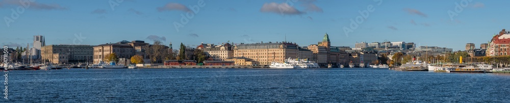 The bays Nybroviken and Ladugårdsviken in Stockholm harbor with boats and piers a colorful autumn day