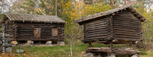 Old log houses from 1600s in a park in Stockholm, a colorful autumn day