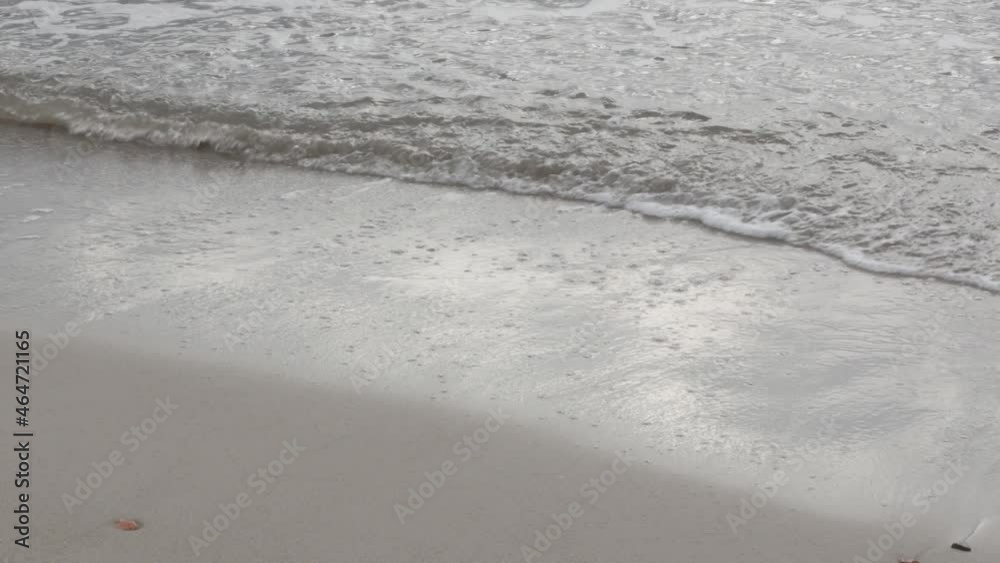 top angle of clean sea waves breaking on sandy beach top angle of clean sea waves breaking on sandy beach