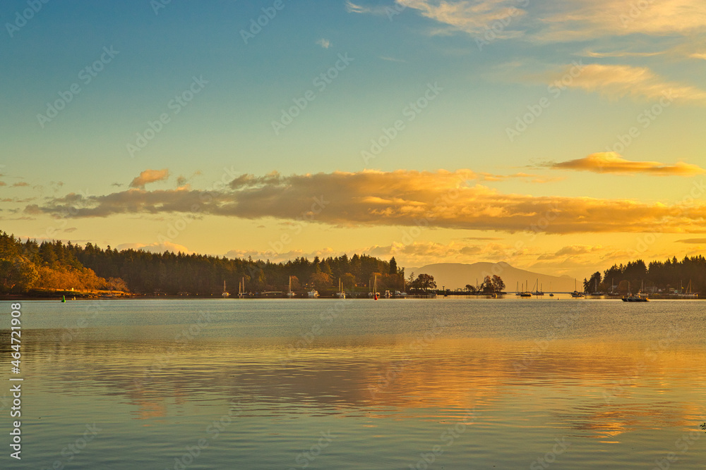A view of a sunrise over the ocean and over protection island and newcastle island in Nanaimo, Vancouver Island, British Colombia, Bc Canada