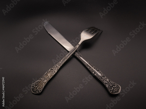 Spoon and fork on dark background