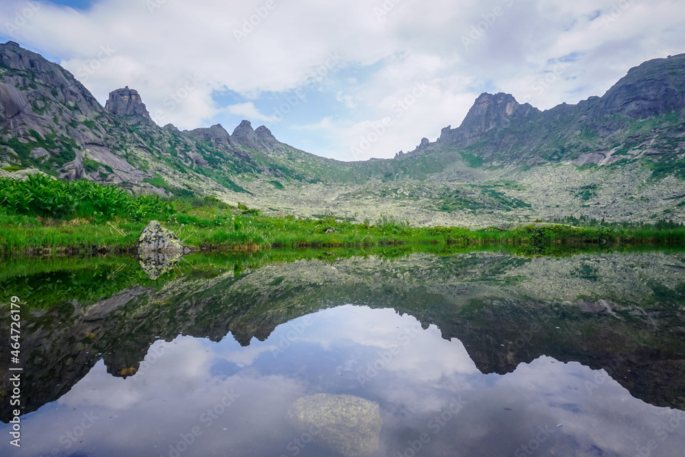 Mountain range in the reflection of the lake in the natural park Ergaki