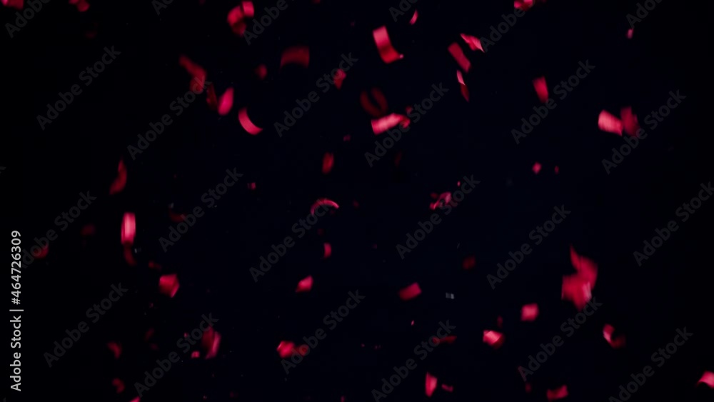 Confetti firecracker on black background. Red party popper explosion close-up. New year and christmas time or birthday. Holidays and celebration concept. Confetti firecracker on black background. Red party popper explosion close-up. New year and christmas time or birthday. Holidays and celebration concept.