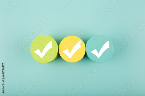 Three white checkmarks on colorful circles against bright aqua blue background