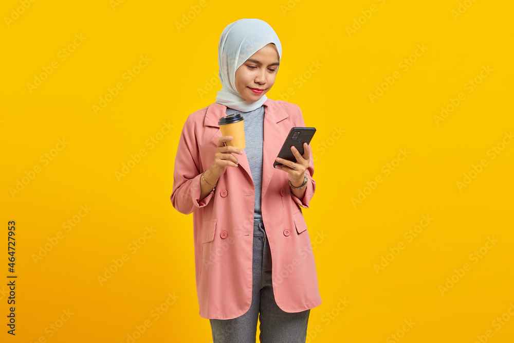 Portrait of beautiful woman holding a folder and showing rock sign against isolated on yellow background