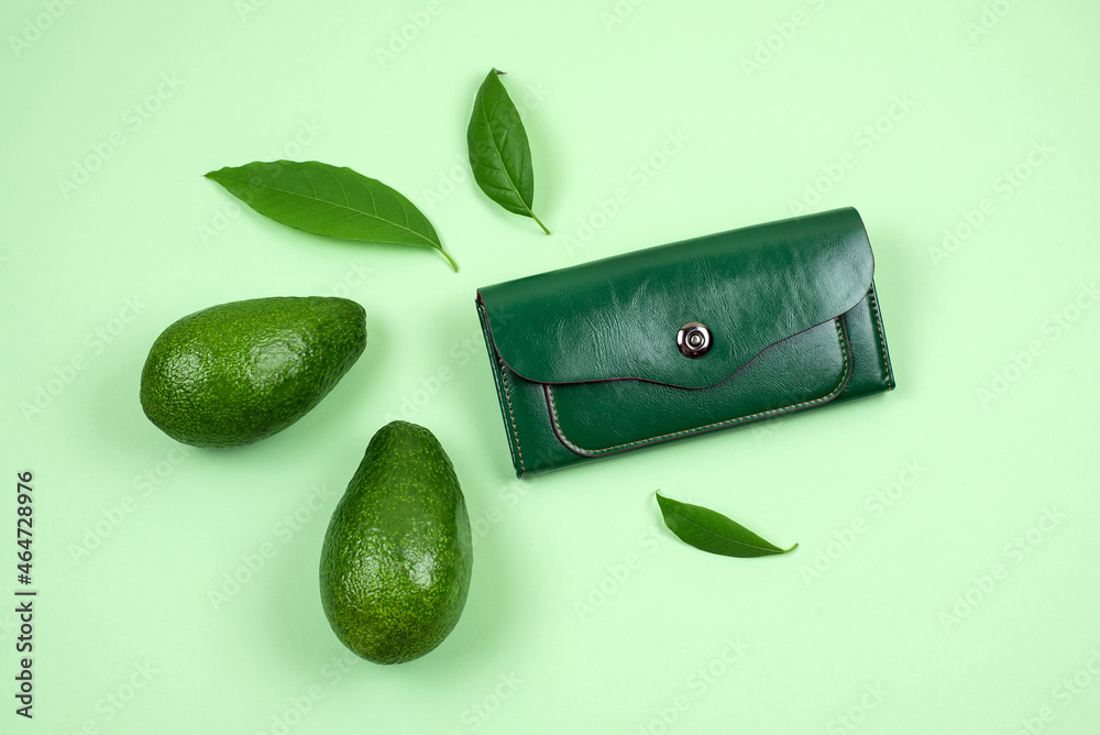 Wallet and avocado on green background. Concept of faux leather made from  avocado peel skin, products alternative instead of animal skins, eco vegan  leather, sustainable innovative materials Stock Photo | Adobe Stock