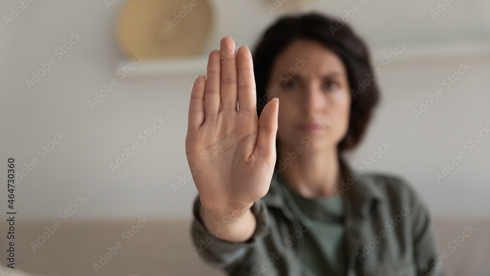 Worried concerned young woman showing palm, making hand stop denial gesture, expressing prohibition, refusal, fighting for equal rights against domestic violence, abuse, discrimination, bullying - obrazy, fototapety, plakaty 