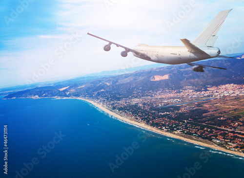 Big jet airplane fly over Mediterranean coast