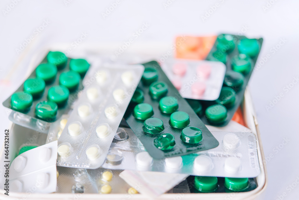 bunch of medical pills in white, pink, green and other colors. Tablets in plastic packaging. Health care and medicine concept. Pharmaceutical industry concept. bunch of medical pills in white, pink, green and other colors. Tablets in plastic packaging. Health care and medicine concept. Pharmaceutical industry concept.
