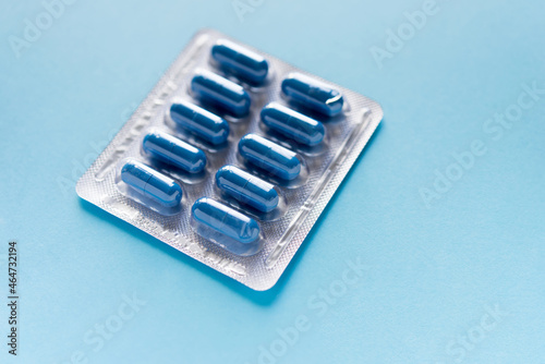 Fotografie blister with pills, capsules of blue color on a blue background