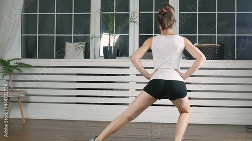 4k footage. Women doing squats exercise at home. Fitness girl doing sport workout in living room