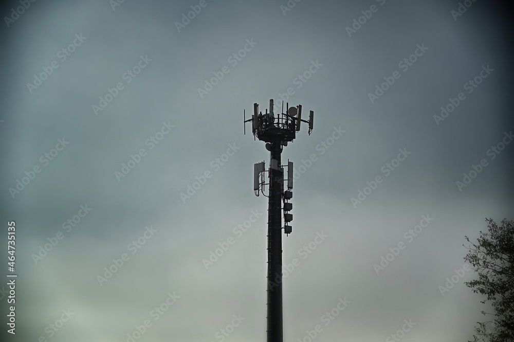 telecommunications antennas tower silhouette under dull sky telecommunications antennas tower silhouette under dull sky