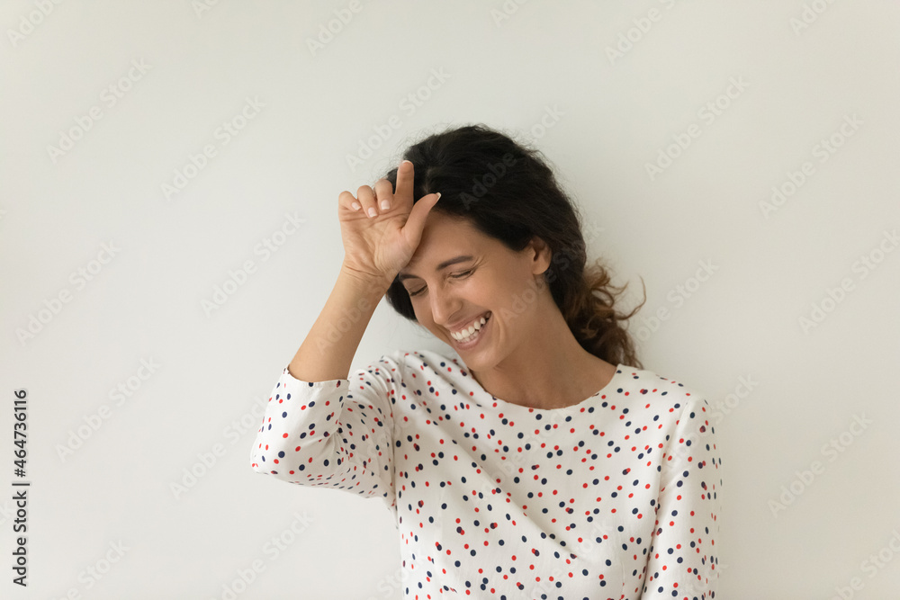 Happy overjoyed beautiful Latin 30s woman laughing out loud, touching face while standing isolated on white background. Cheerful customer expressing joy and having fun. Head shot portrait Happy overjoyed beautiful Latin 30s woman laughing out loud, touching face while standing isolated on white background. Cheerful customer expressing joy and having fun. Head shot portrait