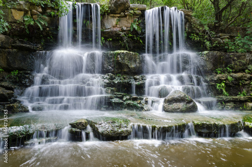 Water from twin waterfalls cascading into a pool.