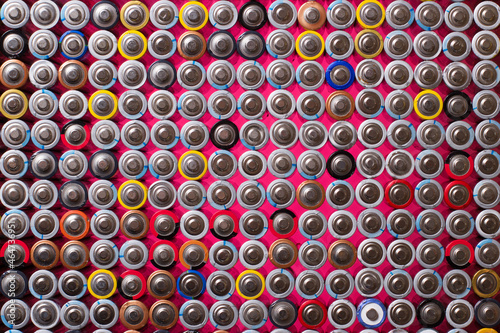alkaline batteries on top of each other on a red background