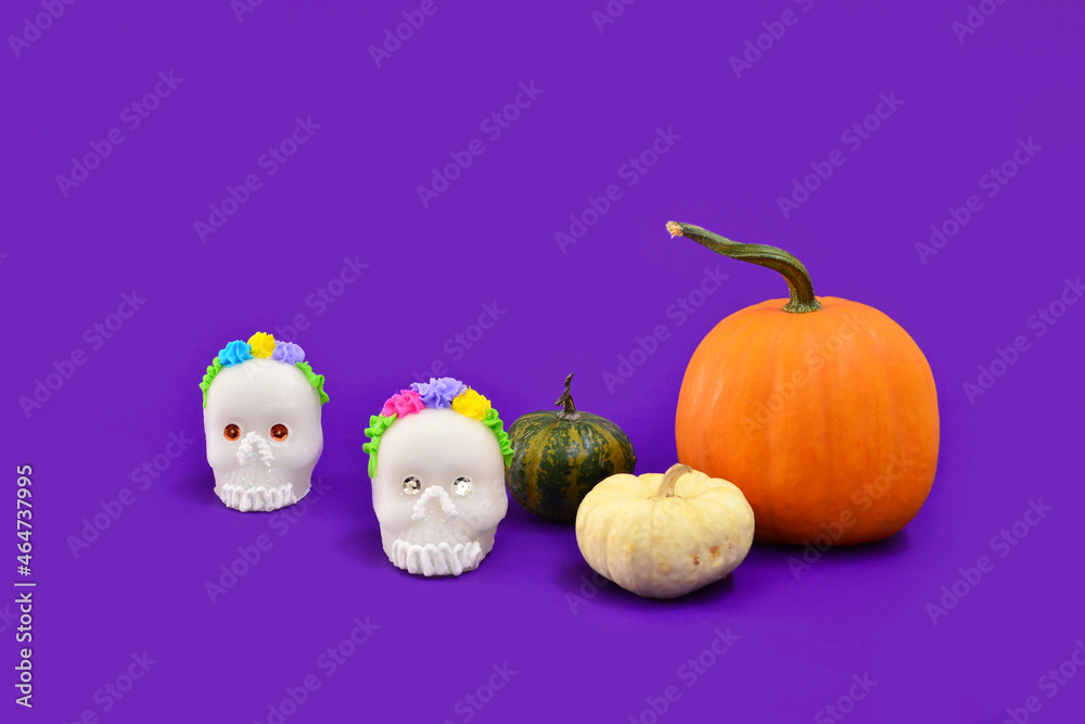 Halloween decoration with pumpkins and skull candies.