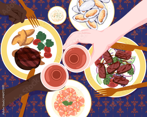 People eating steak meal at restaurant overhead view