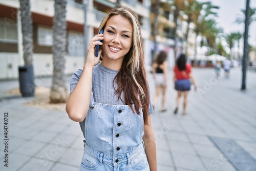 Young caucasian girl smiling happy talking on the smartphone at the city.