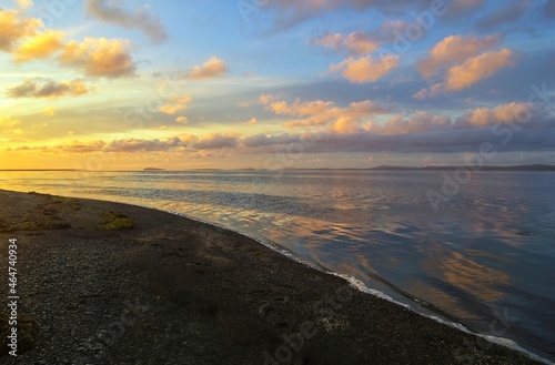 Romantic sunrise over the bay of Happiness ( Shchastya bay ). Sea of Okhotsk coast, Chkalov island. Khabarovsk Krai, far East, Russia.