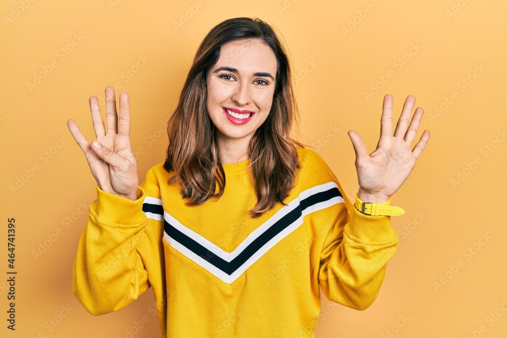Young hispanic girl wearing casual clothes showing and pointing up with fingers number nine while smiling confident and happy. Young hispanic girl wearing casual clothes showing and pointing up with fingers number nine while smiling confident and happy.
