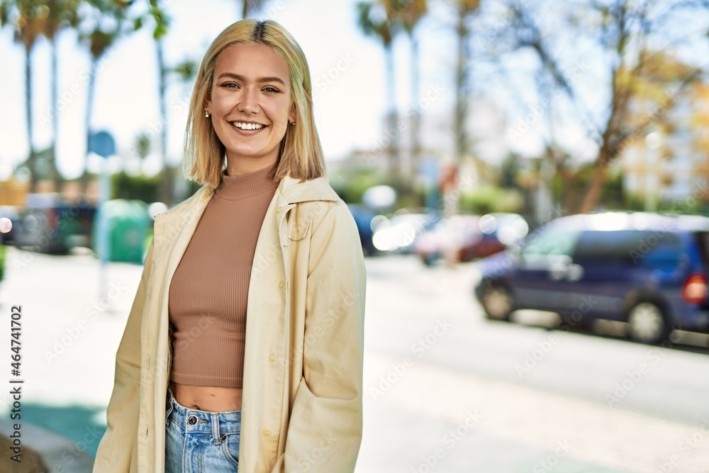 Fototapeta premium Young blonde girl smiling happy standing at the city.