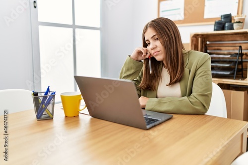 Young hispanic woman working at office