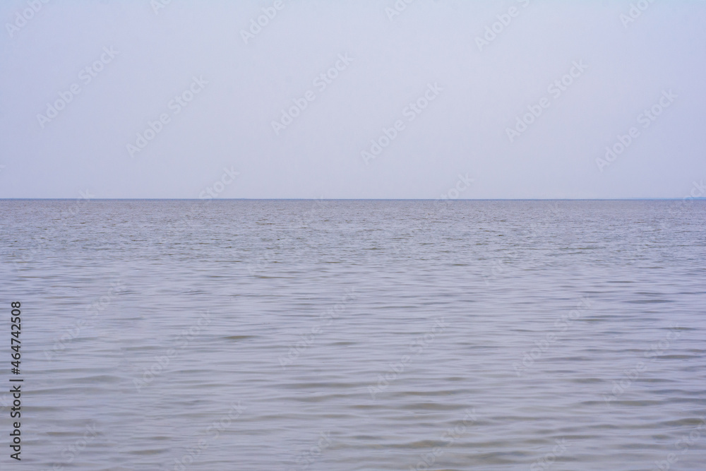 calm sea surface and blue sky. water ripple surface. water background. blue water surface. abstract blue water