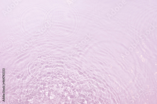 Pink water background with splashing water and flowing circles, great idea for design.