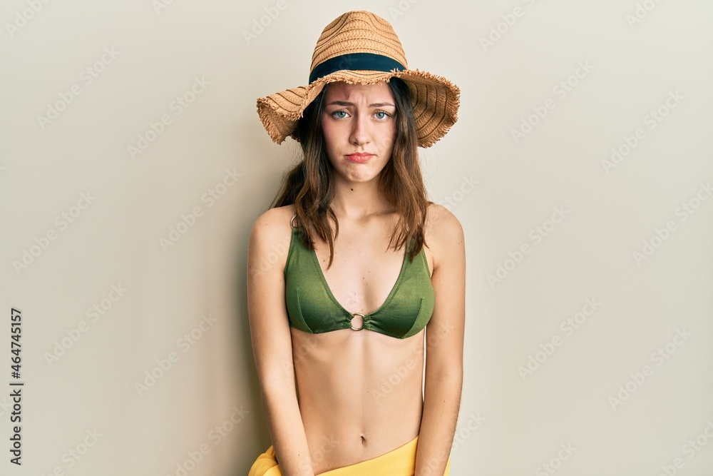 Young brunette woman wearing bikini depressed and worry for distress, crying angry and afraid. sad expression. Young brunette woman wearing bikini depressed and worry for distress, crying angry and afraid. sad expression.