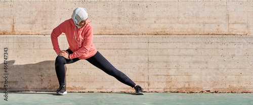 Woman with muslim sport wear stretching