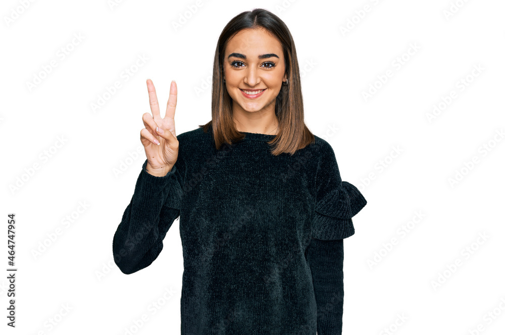 Beautiful brunette woman wearing elegant sweater showing and pointing up with fingers number two while smiling confident and happy. Beautiful brunette woman wearing elegant sweater showing and pointing up with fingers number two while smiling confident and happy.