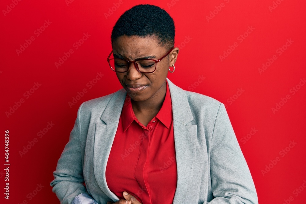 Young african american woman wearing business jacket and glasses with hand on stomach because indigestion, painful illness feeling unwell. ache concept.