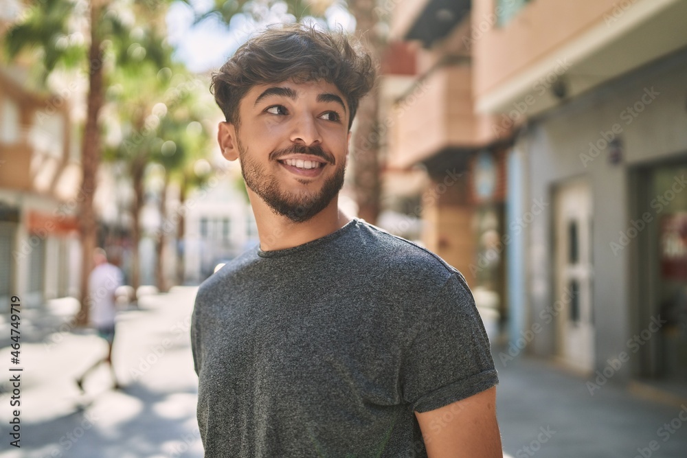 Fototapeta premium Young arab man smiling happy standing at the city.