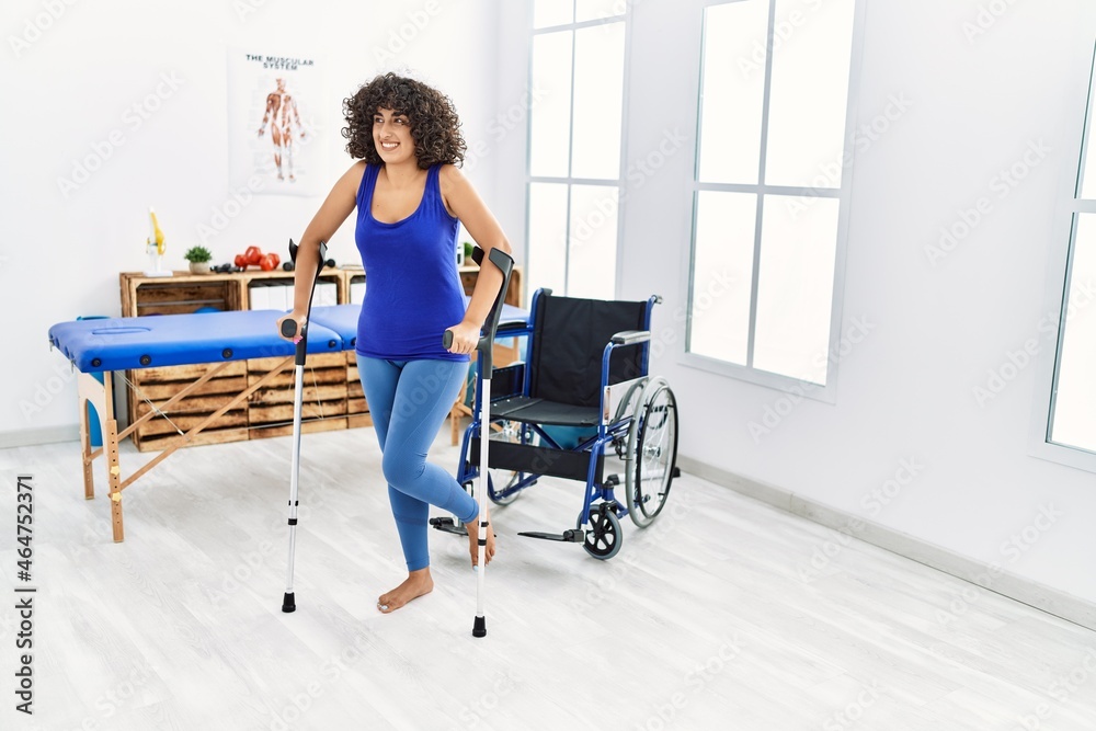 Young middle east woman walking using crutches at clinic Young middle east woman walking using crutches at clinic
