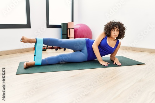 Young middle east woman training using elastic band at sport center