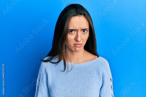 Young hispanic girl wearing casual clothes skeptic and nervous, frowning upset because of problem. negative person.
