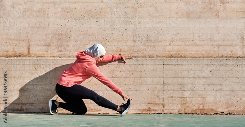 Woman with muslim sport wear stretching