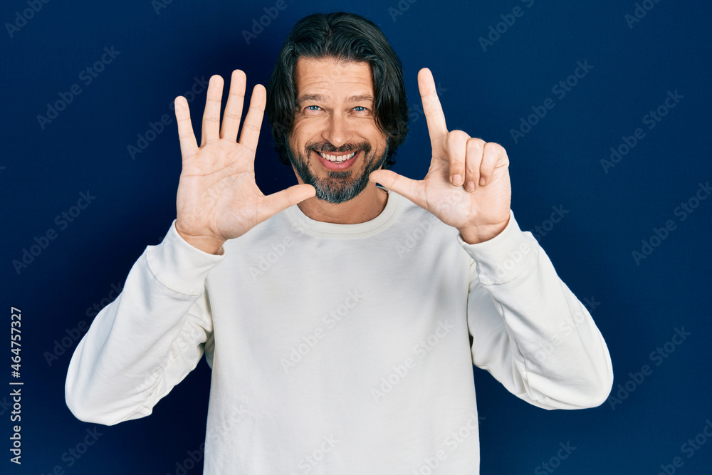 Naklejka premium Middle age caucasian man wearing casual clothes showing and pointing up with fingers number seven while smiling confident and happy.