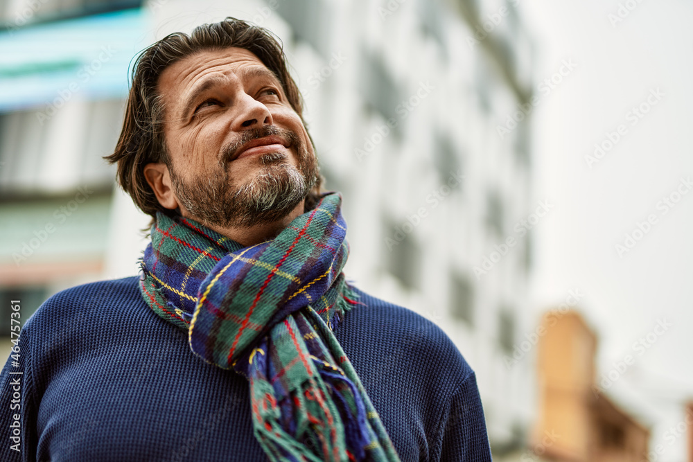 Middle age handsome man smiling at the town Middle age handsome man smiling at the town