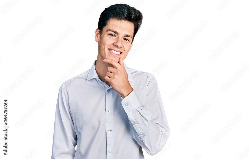 Young hispanic business man wearing business clothes looking confident at the camera with smile with crossed arms and hand raised on chin. thinking positive. Young hispanic business man wearing business clothes looking confident at the camera with smile with crossed arms and hand raised on chin. thinking positive.