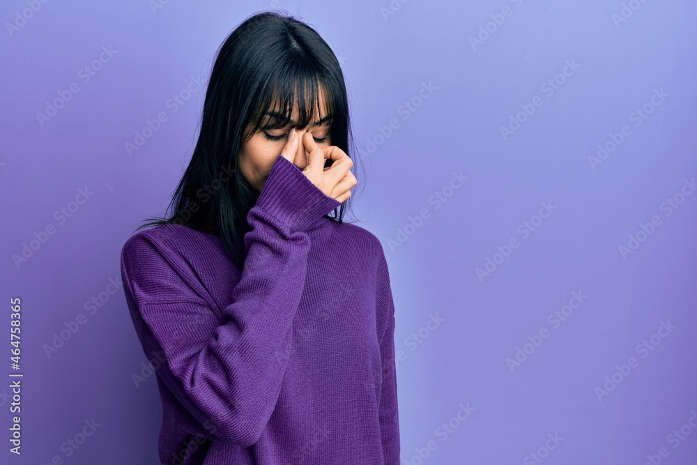 Young brunette woman with bangs wearing turtleneck sweater tired rubbing nose and eyes feeling fatigue and headache. stress and frustration concept. Young brunette woman with bangs wearing turtleneck sweater tired rubbing nose and eyes feeling fatigue and headache. stress and frustration concept.