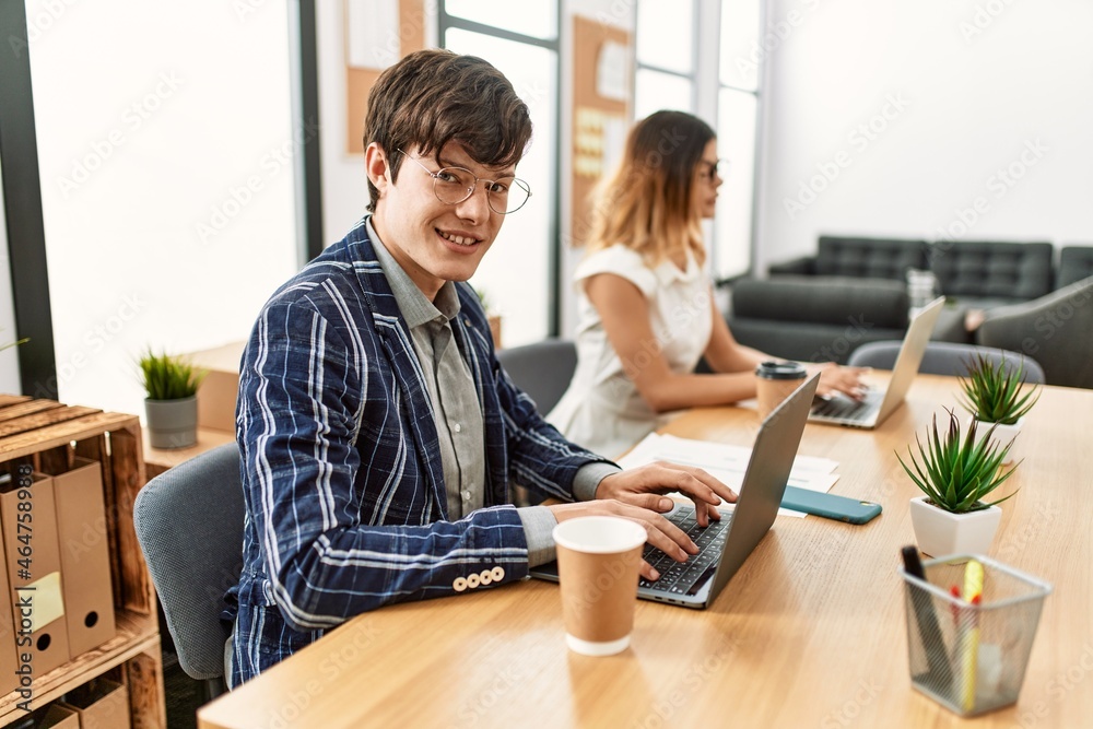 Two business workers smiling happy working at the office. Two business workers smiling happy working at the office.