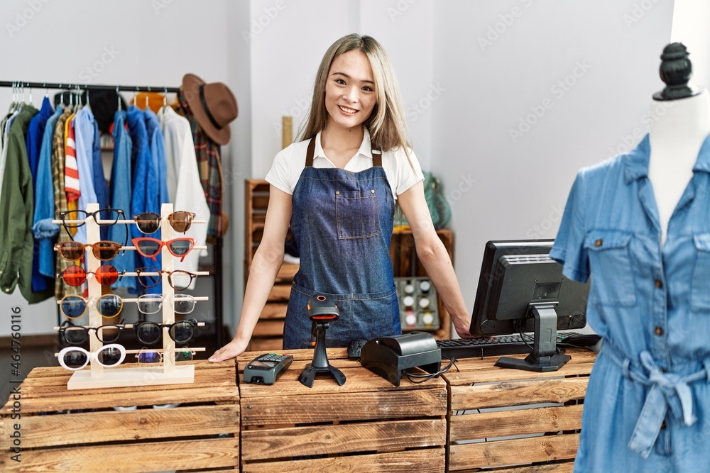 Young chinese woman smiling confident working at clothing store Young chinese woman smiling confident working at clothing store