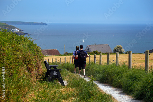 Two young men walking on a path in a neighborhood close to Crosshaven and Templebreedy, Cork, Ireland photo