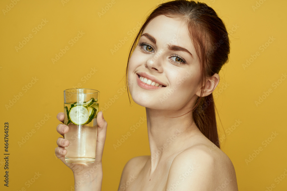 woman with cucumber drink vitamins body care yellow background woman with cucumber drink vitamins body care yellow background