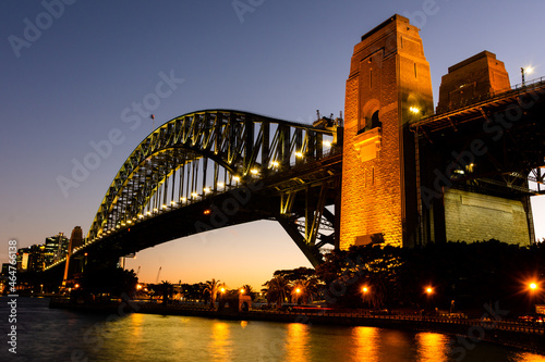 Side view of Sydney Harbour Bridge from Copes Lookout, North Sydney in the evening. Blue and golden sky in the background.