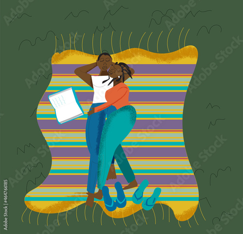 Gay couple laying on the grass cuddling