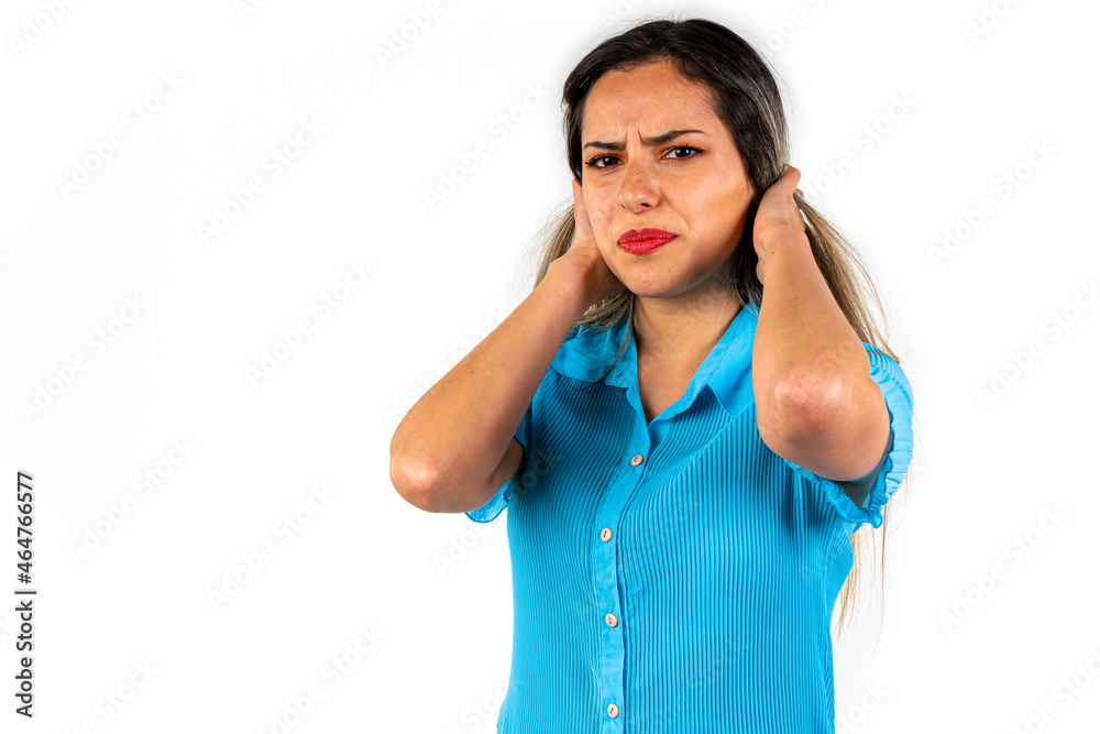 Beautiful young woman with an expression of frustration, pain and sadness as she holds her hair with both hands. Beautiful young woman with an expression of frustration, pain and sadness as she holds her hair with both hands.