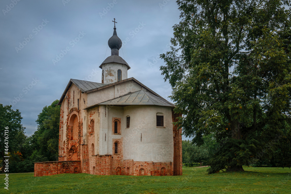 View of the Church of St. Paraskevi (Paraskevy Pyatnitsy na Torgu) on the territory of Yaroslavovo Dvorishche on a cloudy summer day, Veliky Novgorod, Russia View of the Church of St. Paraskevi (Paraskevy Pyatnitsy na Torgu) on the territory of Yaroslavovo Dvorishche on a cloudy summer day, Veliky Novgorod, Russia