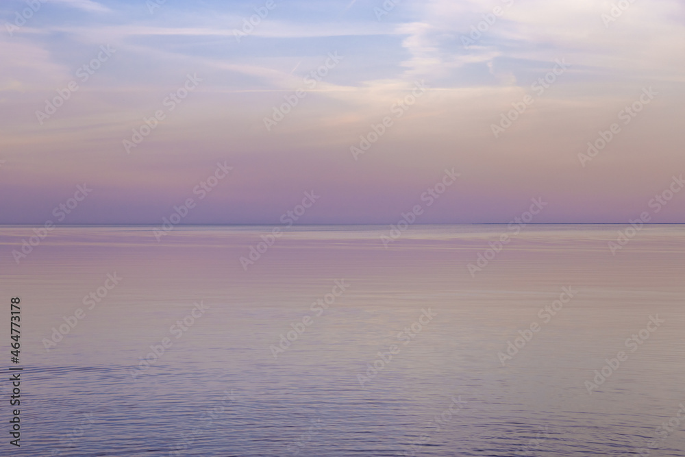Beautiful sunset on sea, pastel colors and reflections on water, calm nature landscape with colorful clouds Beautiful sunset on sea, pastel colors and reflections on water, calm nature landscape with colorful clouds